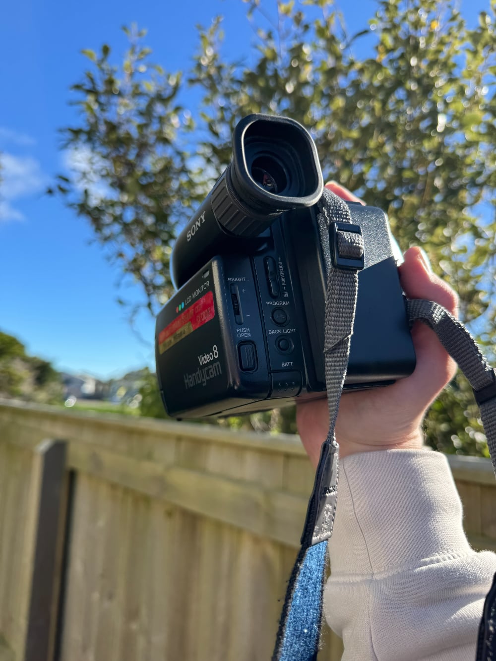 Photo of a hand holding a camcorder